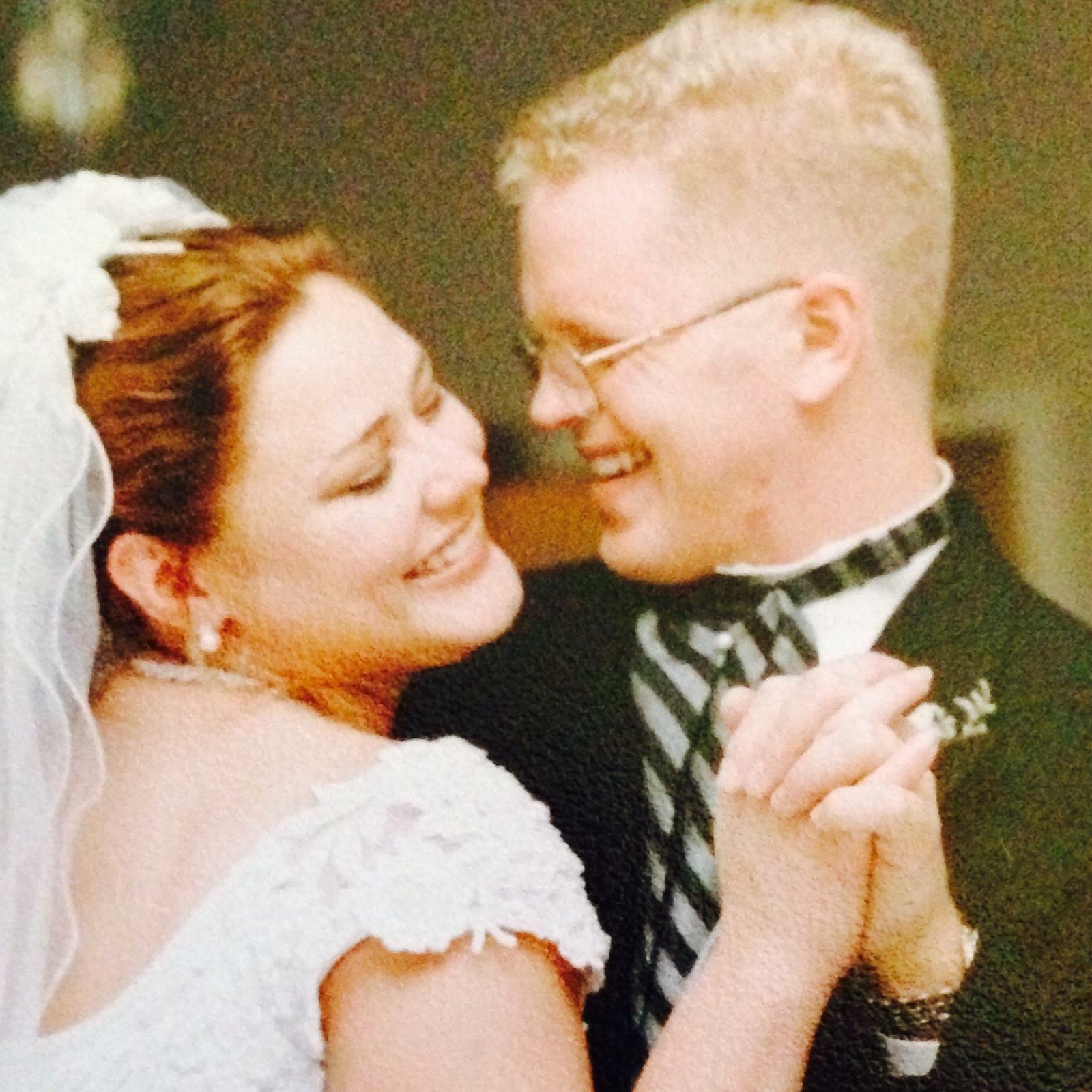 Faye in her veil and Jim laughing during their first dance on their wedding day