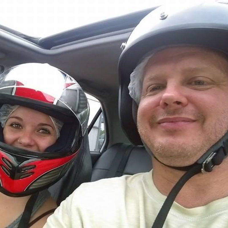 Jim and James in helmets in the car on a track day