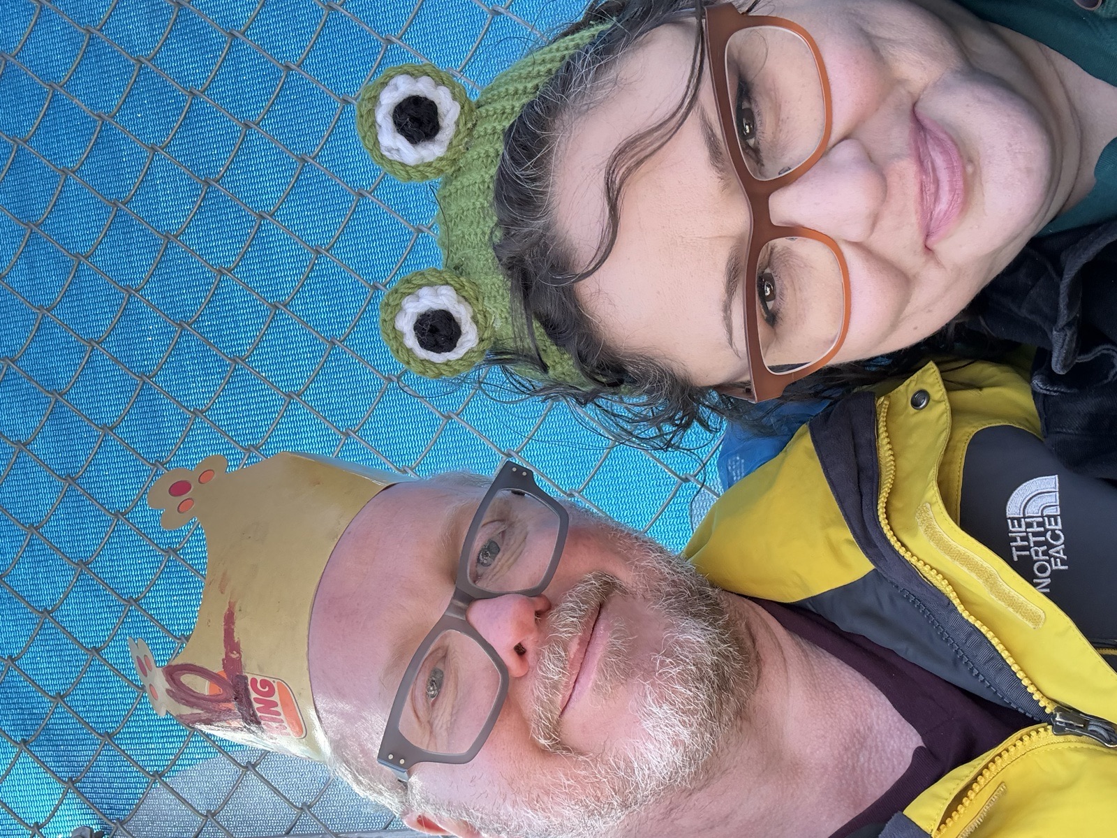 Faye and Jim in a frog hat and a paper crown in St. Paul
