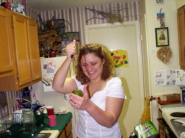 Faye laughing in the Stumberg Lane apartment kitchen, holding a knife over a lime