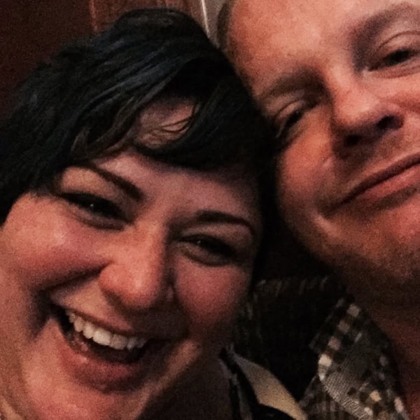 Faye and Jim laughing together in a close-up